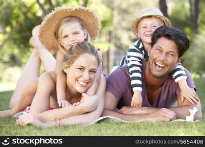 Family Relaxing In Park Together