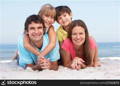 Family Relaxing On Beach Holiday