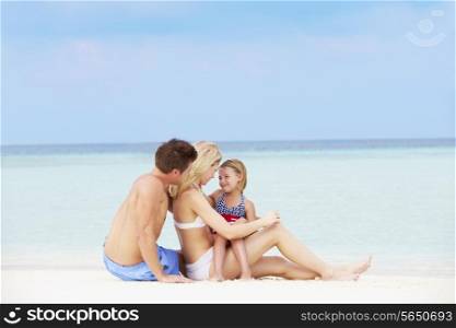 Family Relaxing On Beautiful Beach Together