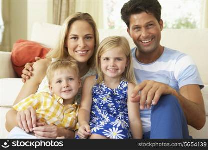 Family Relaxing On Sofa At Home