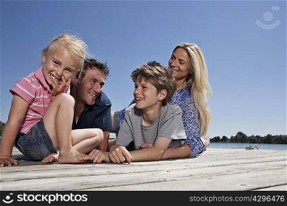 Family relaxing together on dock