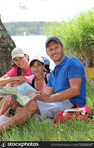 Family resting in the grass on a hiking day
