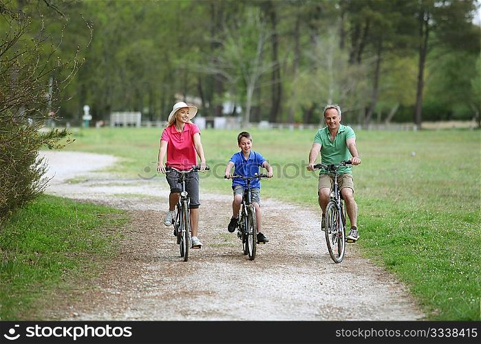 Family riding bicycles in countryside