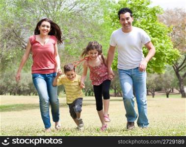 Family running on green grass field,outdoor