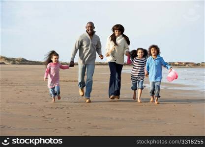 Family Running On Winter Beach