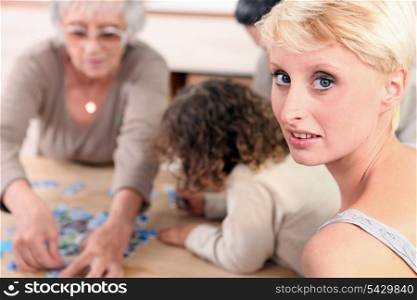 Family sat by table playing game