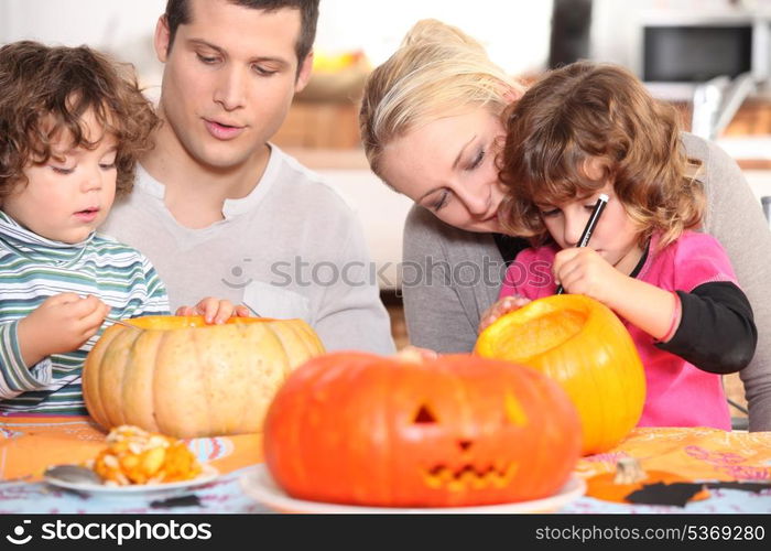 Family sculpting pumpkins