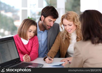 Family signing real-estate contract