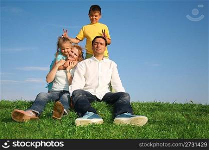 family sitting grass