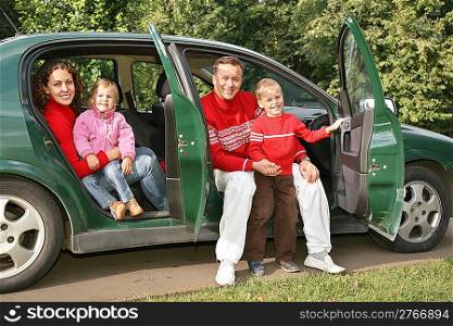 family sitting in car
