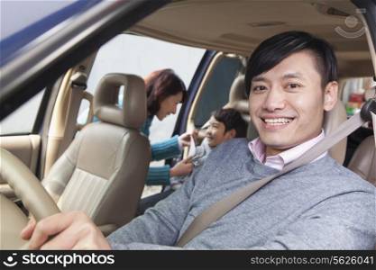 Family sitting in car, Beijing