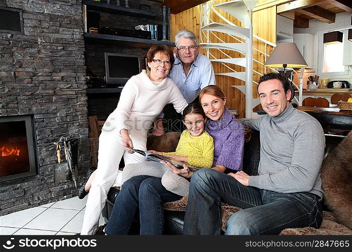 Family sitting in front of a fire