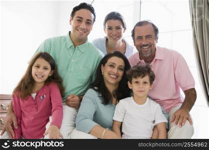 Family sitting in living room smiling (high key)