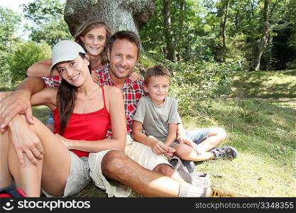 Family sitting in nature on a hiking day