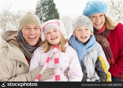 Family Sitting In Snowy Landscape