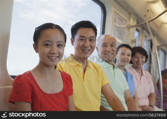 Family sitting in the subway, portrait