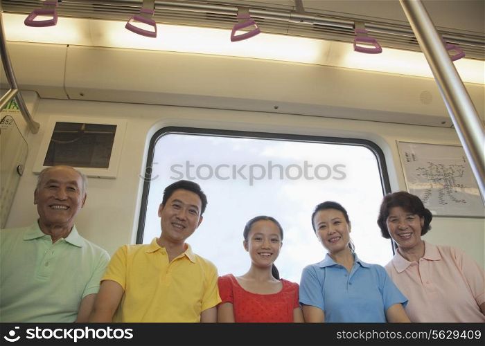 Family sitting in the subway, portrait