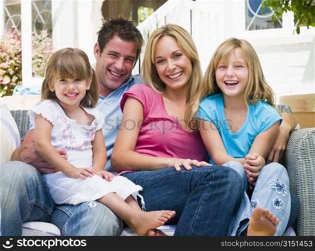 Family sitting on patio smiling