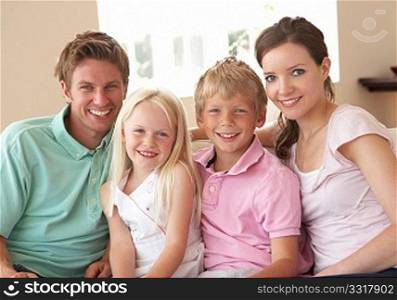 Family Sitting On Sofa At Home Together
