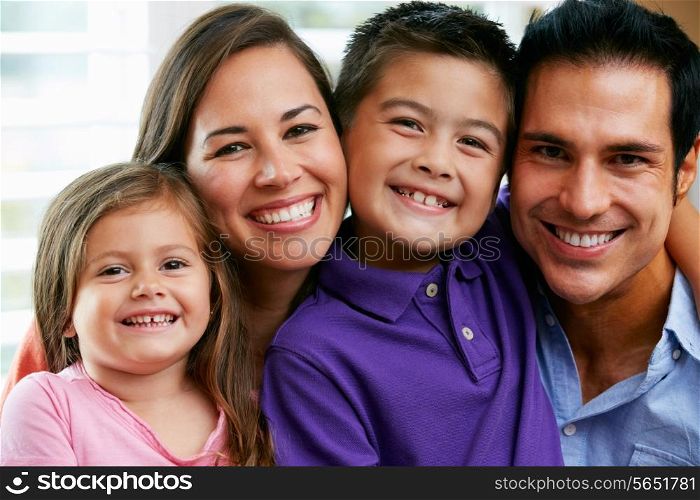 Family Sitting On Sofa At Home Together