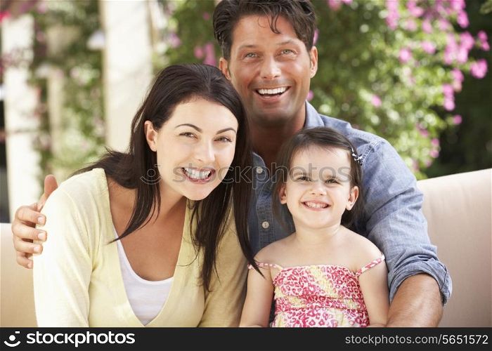 Family Sitting On Sofa Together