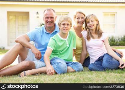Family Sitting Outside Dream Home