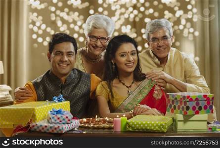 Family sitting together and Smiling with gifts on the occasion of diwali