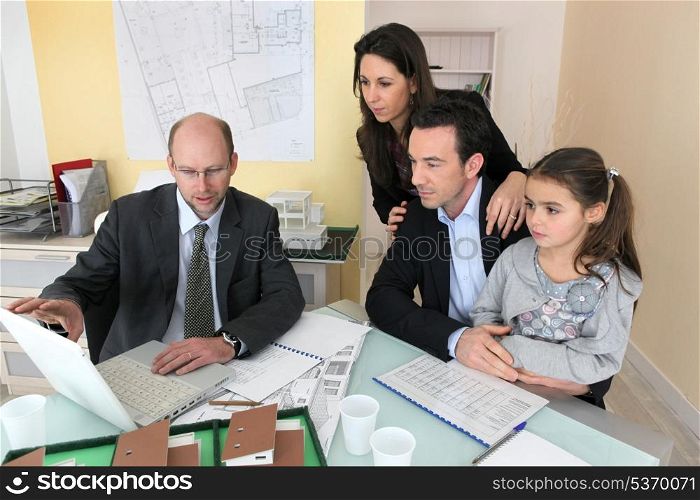 Family sitting with an architect