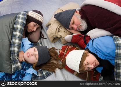 Family sleeping in tent