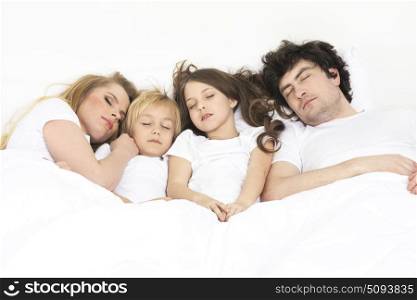 Family sleeping together. Cute family sleeping together in the parents&rsquo;s bed