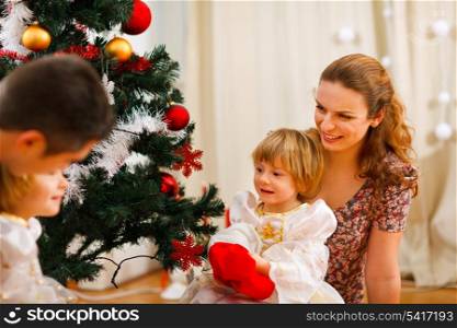 Family spending time near Christmas tree
