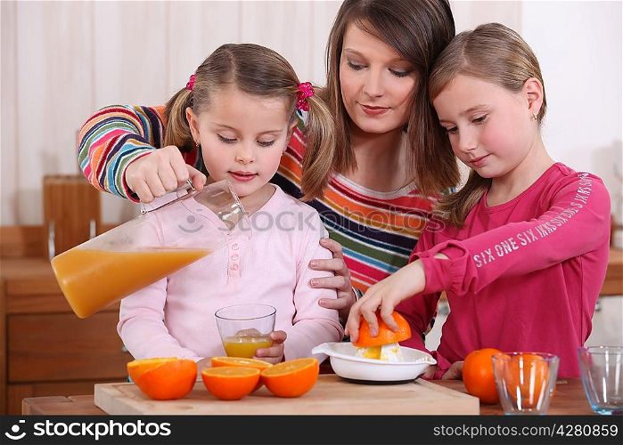 Family squeezing fresh orange juice