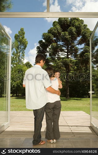 Family standing at doors to garden