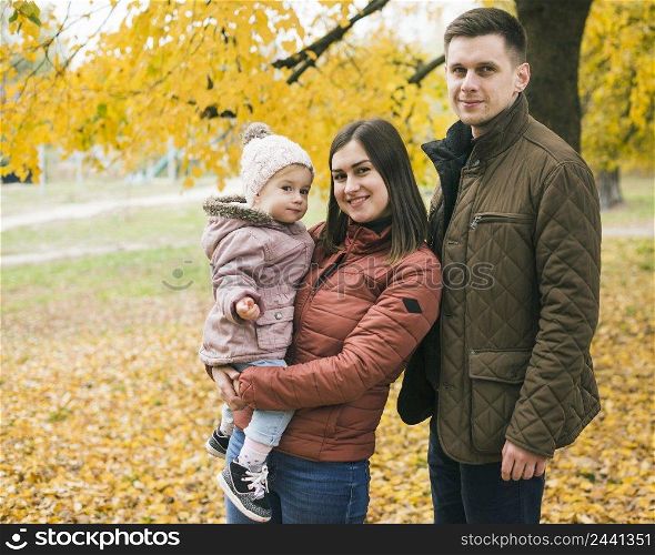 family standing autumn park