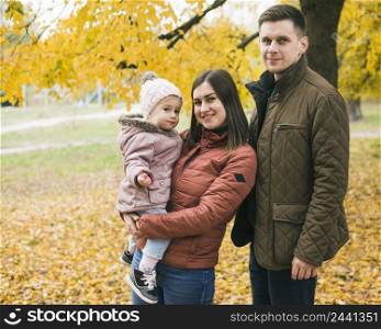 family standing autumn park