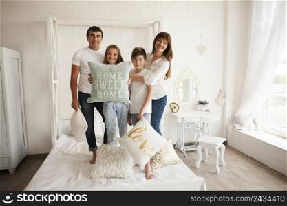 family standing bed with holding home sweet home text pillow
