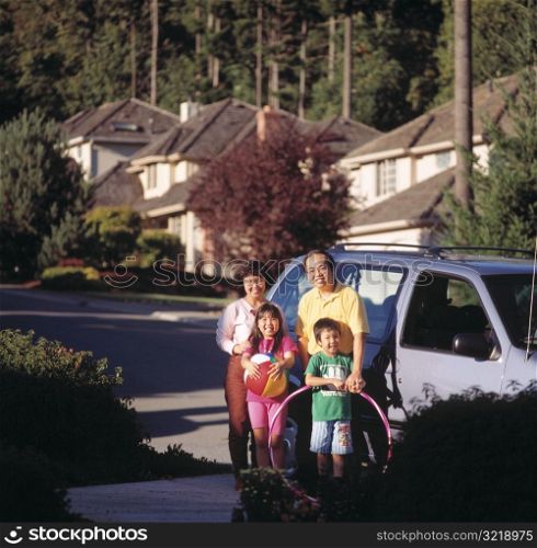 Family Standing by Minivan