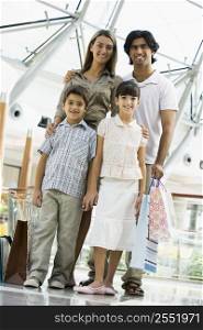Family standing in mall smiling (selective focus)