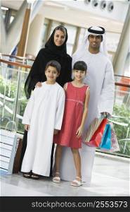 Family standing in mall smiling (selective focus)