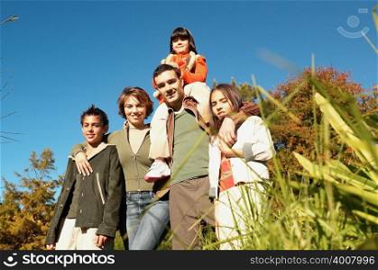 Family standing in meadow