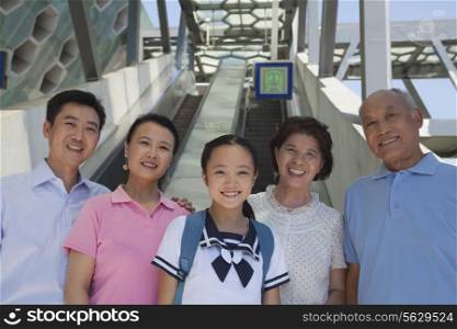 Family standing next to the escalator near the subway station