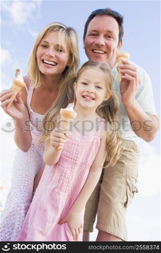 Family standing outdoors with ice cream smiling