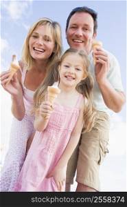Family standing outdoors with ice cream smiling