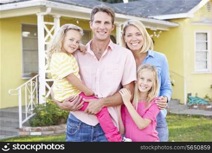 Family Standing Outside Suburban Home