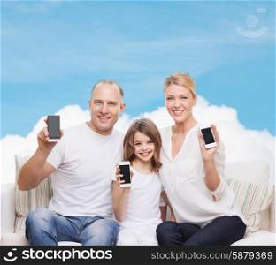 family, technology, advertisement and people concept - smiling mother, father and little girl with smartphones over blue sky and white cloud background
