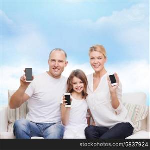 family, technology, advertisement and people concept- smiling mother, father and little girl with smartphones over blue sky background