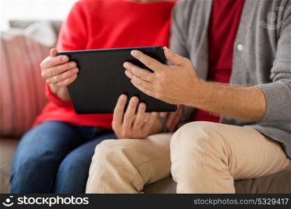 family, technology, age and people concept - close up of senior couple with tablet pc computer at home. close up of senior couple with tablet pc at home