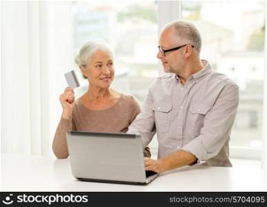 family, technology, age and people concept - happy senior couple with laptop computer and credit card at home