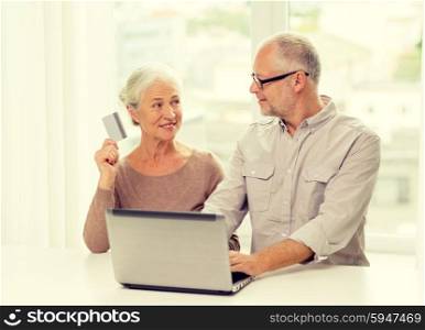 family, technology, age and people concept - happy senior couple with laptop computer and credit card at home