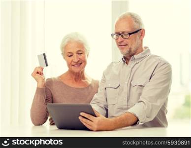 family, technology, age and people concept - happy senior couple with tablet pc computer and credit card at home
